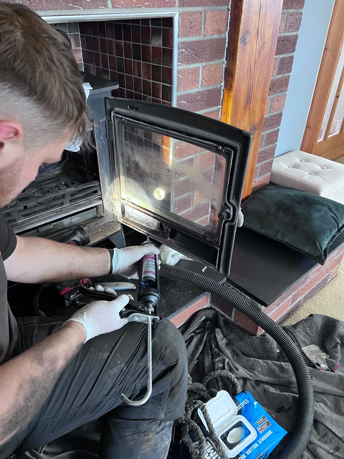 New fire rope being fitted to a stove door